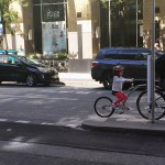 family bikes in traffic because hornby street separated bike lane is blocked by a moving truck