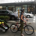 And here's another photo of a mom with two little kids on a separate bike lane on Dunsmuir Street, Vancouver. To me it is just painfully obvious that these little children need to be kept separate from cars that could kill them. And the research supports me - separate bike lanes are a WHOLE lot safer than mixing up bikes and cars